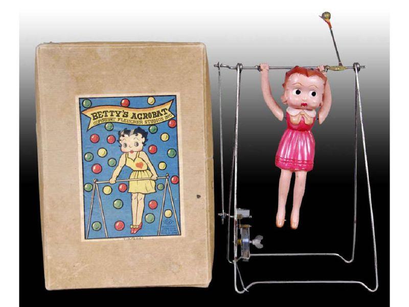 Appraisal: Acrobat Betty Boop Celluloid Wind-Up Trapeze Toy w Description Box