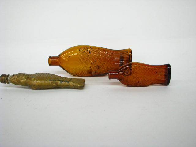 Appraisal: Group of three fish-motif antique bottles including whiskey flask with