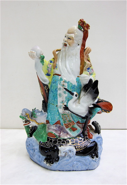 Appraisal: CHINESE PORCELAIN FIGURE of a standing elder with a dragon