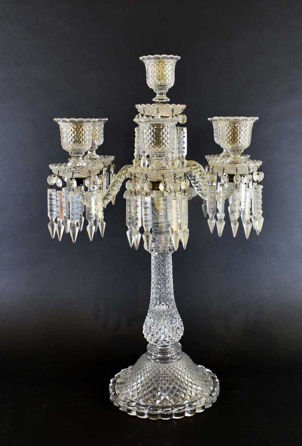 Appraisal: VICTORIAN SEVEN-LIGHT CUT GLASS CANDELABRAThe scrolled arms set into a