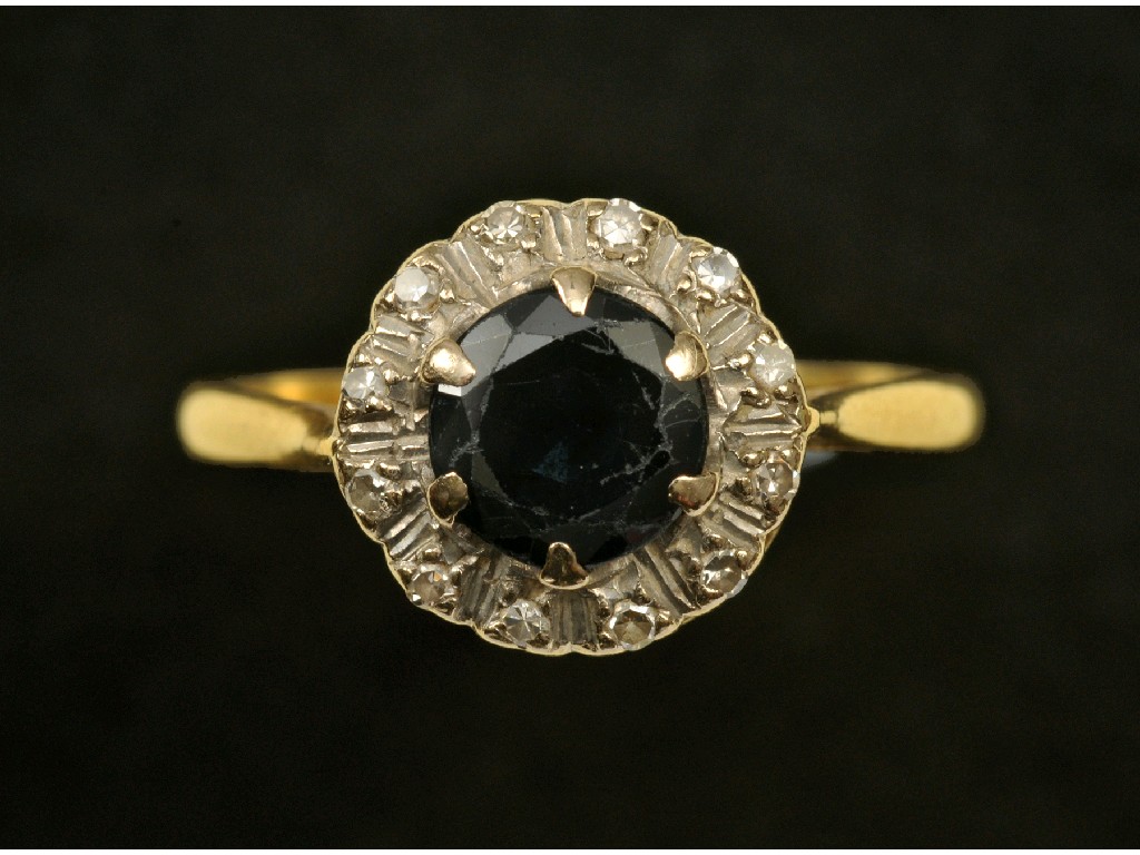 Appraisal: A Sapphire and Diamond Cluster Ring the circular-cut sapphire claw-set