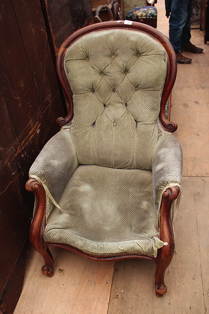 Appraisal: A VICTORIAN MAHOGANY ARMCHAIR with shaped back and scrolling arm