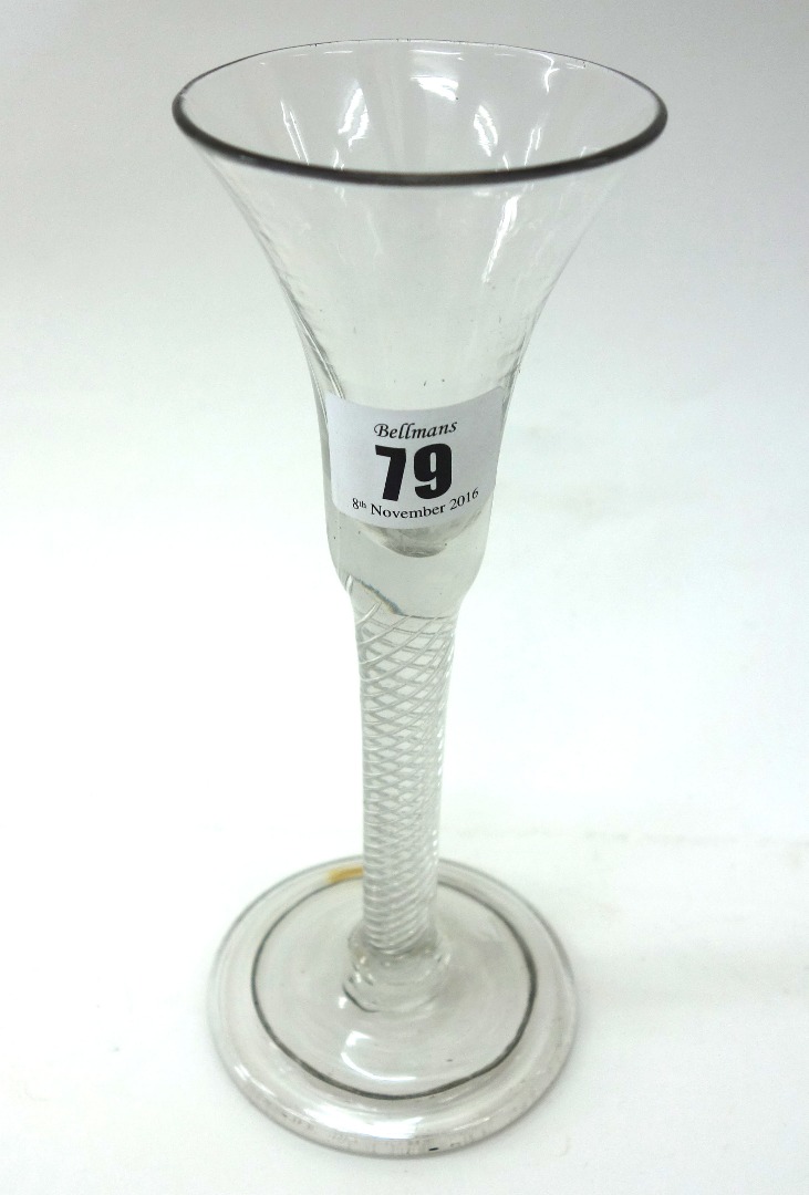 Appraisal: An English cordial glass with trumpet bowl and multi-spiral stem