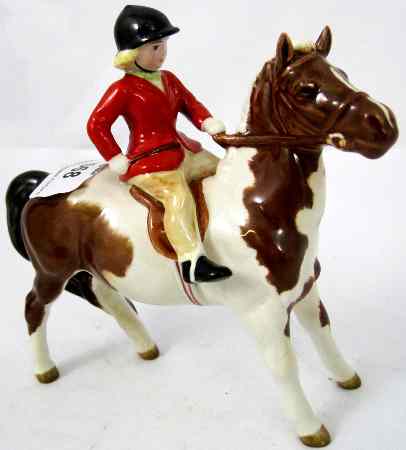 Appraisal: Beswick Girl On Skewbald Pony Wearing Red Jacket