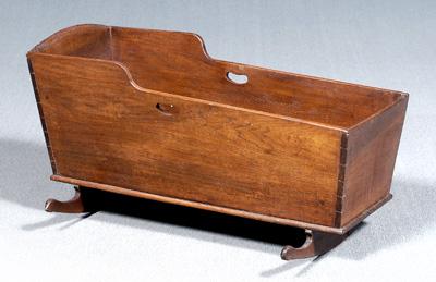 Appraisal: Dovetailed walnut cradle dovetailed case with cutout carrying handles shaped