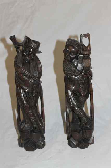 Appraisal: A PAIR OF CHINESE HARDWOOD CARVED MODELS OF IMMORTALS with