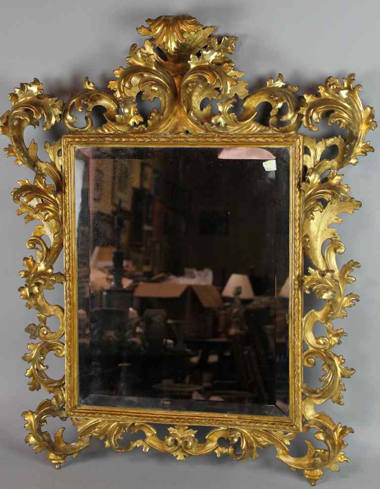 Appraisal: CONTINENTAL GILTWOOD MIRROR th century the rectangular beveled mirror within