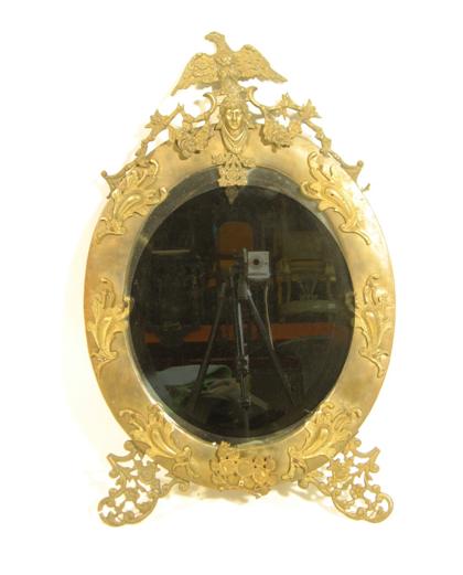 Appraisal: French Neoclassical style gilt metal mirrorThe oval mirror plate surmounted