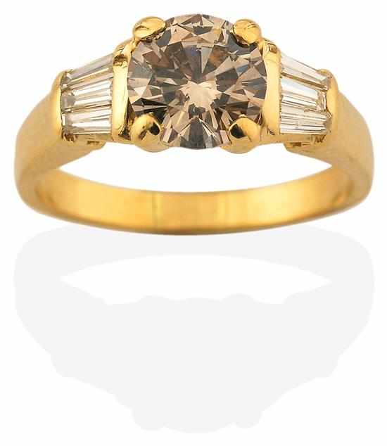 Appraisal: A COGNAC DIAMOND RING Centrally set with a round brilliant