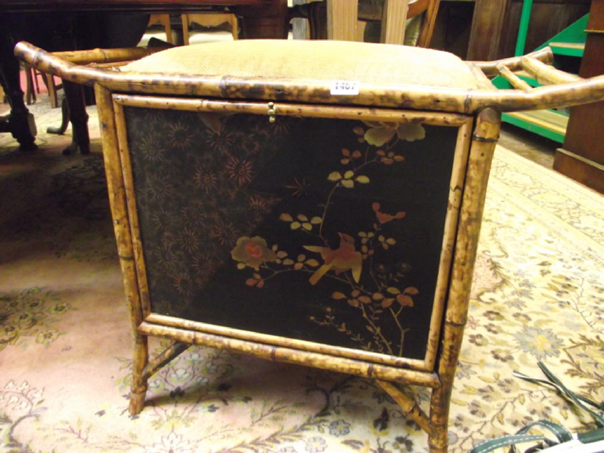 Appraisal: A Victorian bamboo music stool with fall front and upholstered