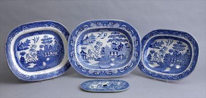 Appraisal: THREE BLUE TRANSFER-PRINTED BLUE WILLOW PLATTERS AND A STRAINER The