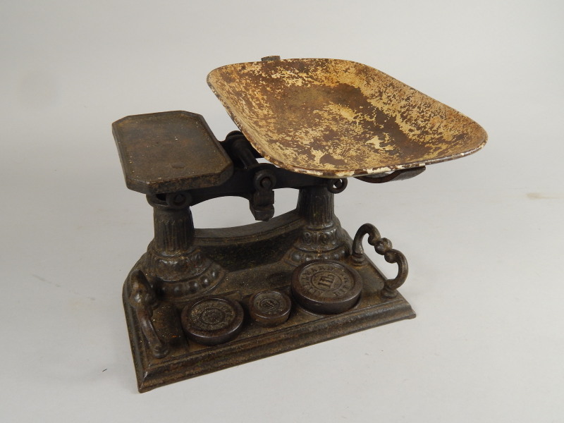 Appraisal: A set of cast iron scales and weights with an