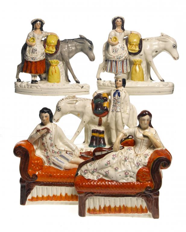 Appraisal: A PAIR OF STAFFORDSHIRE EARTHENWARE FIGURES OF MUSICIANS reclining on