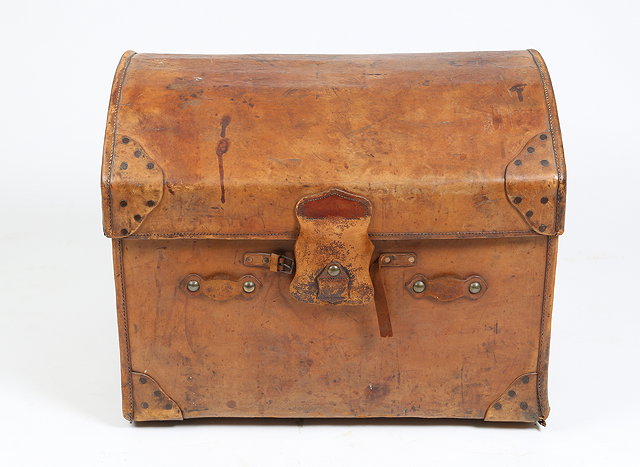 Appraisal: AN OLD DOME TOPPED BROWN LEATHER TRUNK the interior with