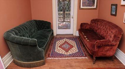 Appraisal: TWO VICTORIAN PLUSH-UPHOLSTERED SOFAS Each with deep-buttoned and pleated back