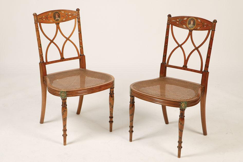 Appraisal: A PAIR OF PAINTED SATINWOOD SALON CHAIRS the top rails