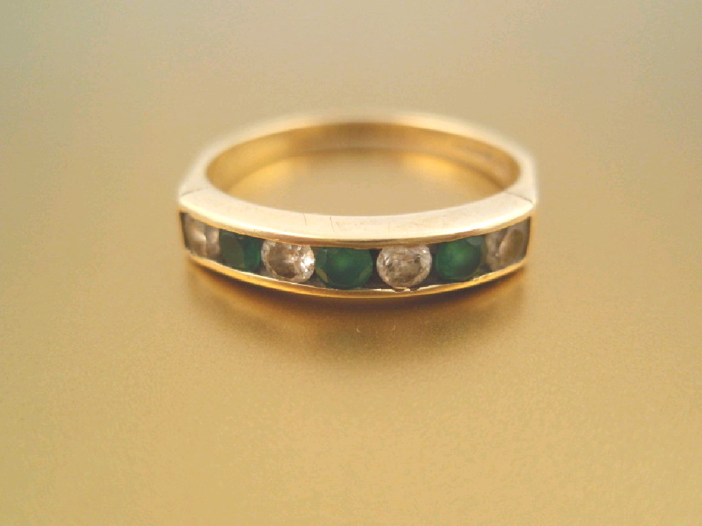 Appraisal: An in-line stone set ring of alternating four small diamonds