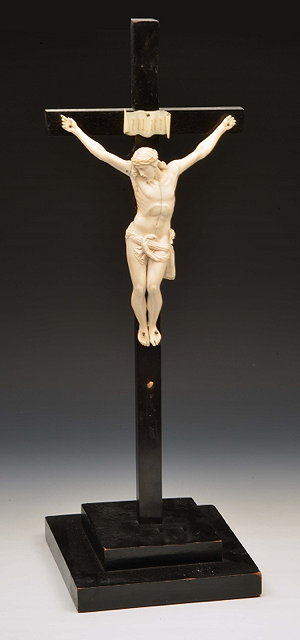 Appraisal: AN IVORY CRUCIFIX figure on an ebony cross with stepped