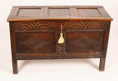 Appraisal: A late th Century oak chest with triple panel hinged