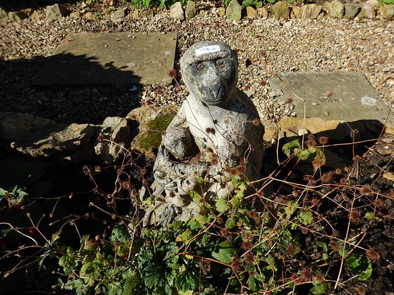 Appraisal: A reconstituted stone garden figure group of two monkeys on