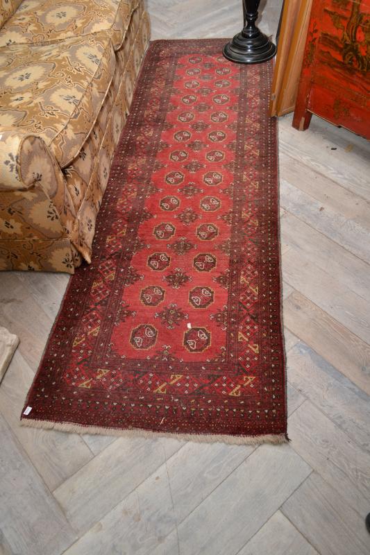 Appraisal: AN AFGHAN HANDKNOTTED RUNNER IN RED AN AFGAHN HANDKNOTTED RUNNER