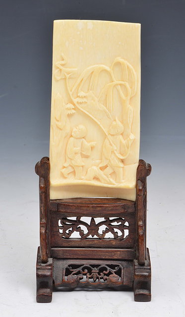 Appraisal: A CHINESE IVORY CURVED WRIST REST two boys flying a