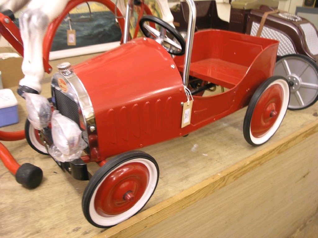 Appraisal: A child's pedal car galvanised metal finished in red with