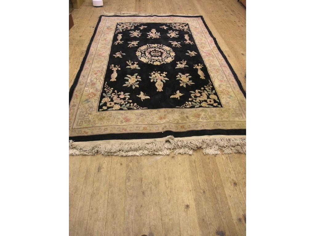 Appraisal: A Chinese wool carpet floral designs against a black ground