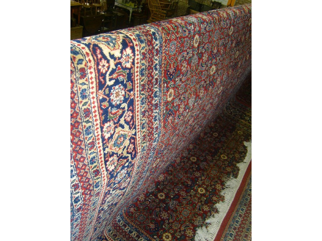 Appraisal: A heavy wool carpet in the Persian style the red