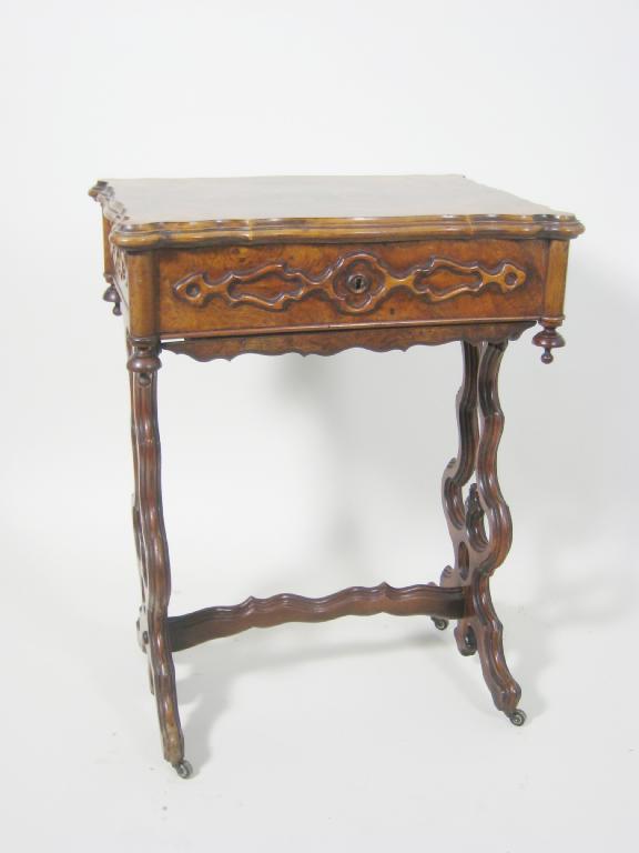 Appraisal: A Victorian walnut Sewing Table with moulded hinged top raised