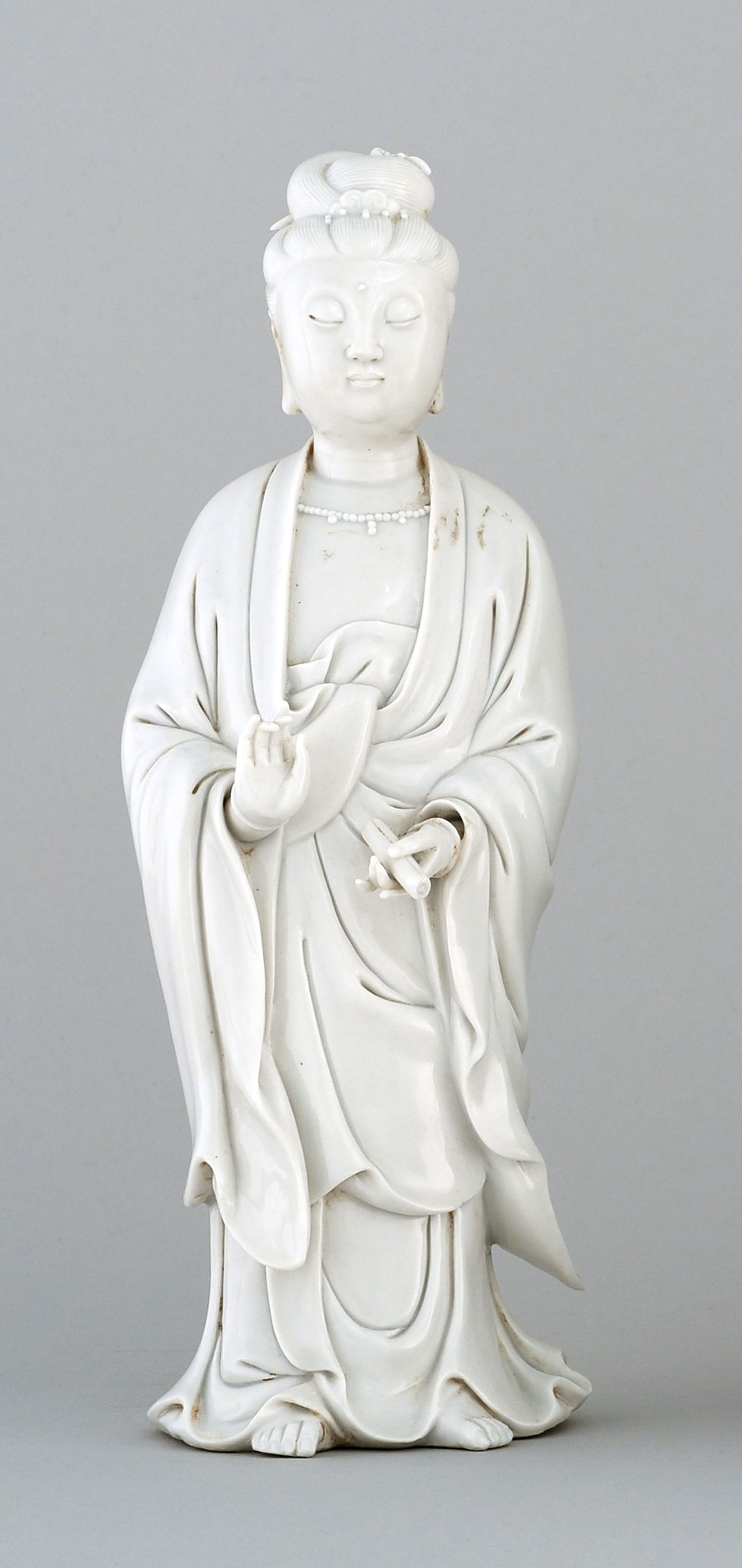 Appraisal: BLANC DE CHINE PORCELAIN FIGURE th CenturyDepicting Guanyin standing while