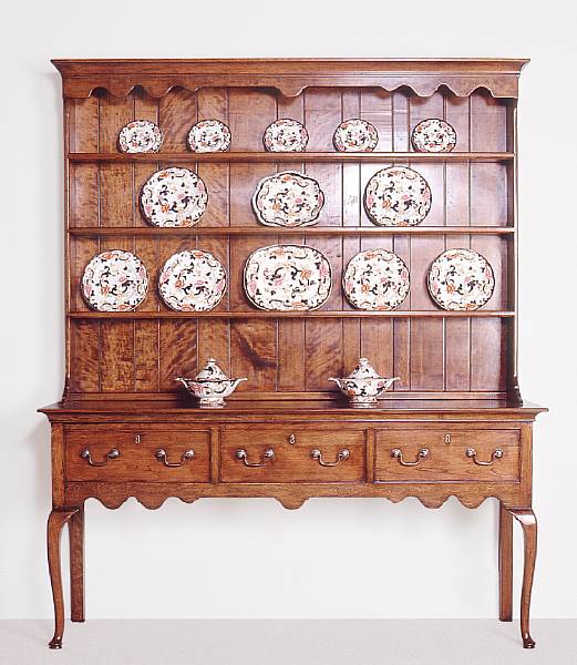 Appraisal: A George II style cherrywood dresser The molded and scalloped