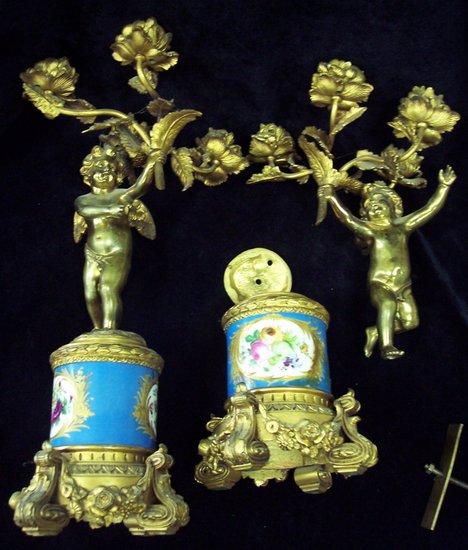 Appraisal: A pair of gilt metal four-light candelabra modelled as cherubs