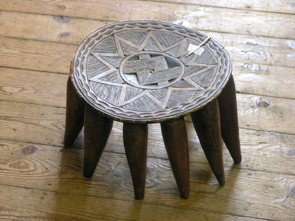 Appraisal: An Ashanti-type tribal stool circular top with an incised star