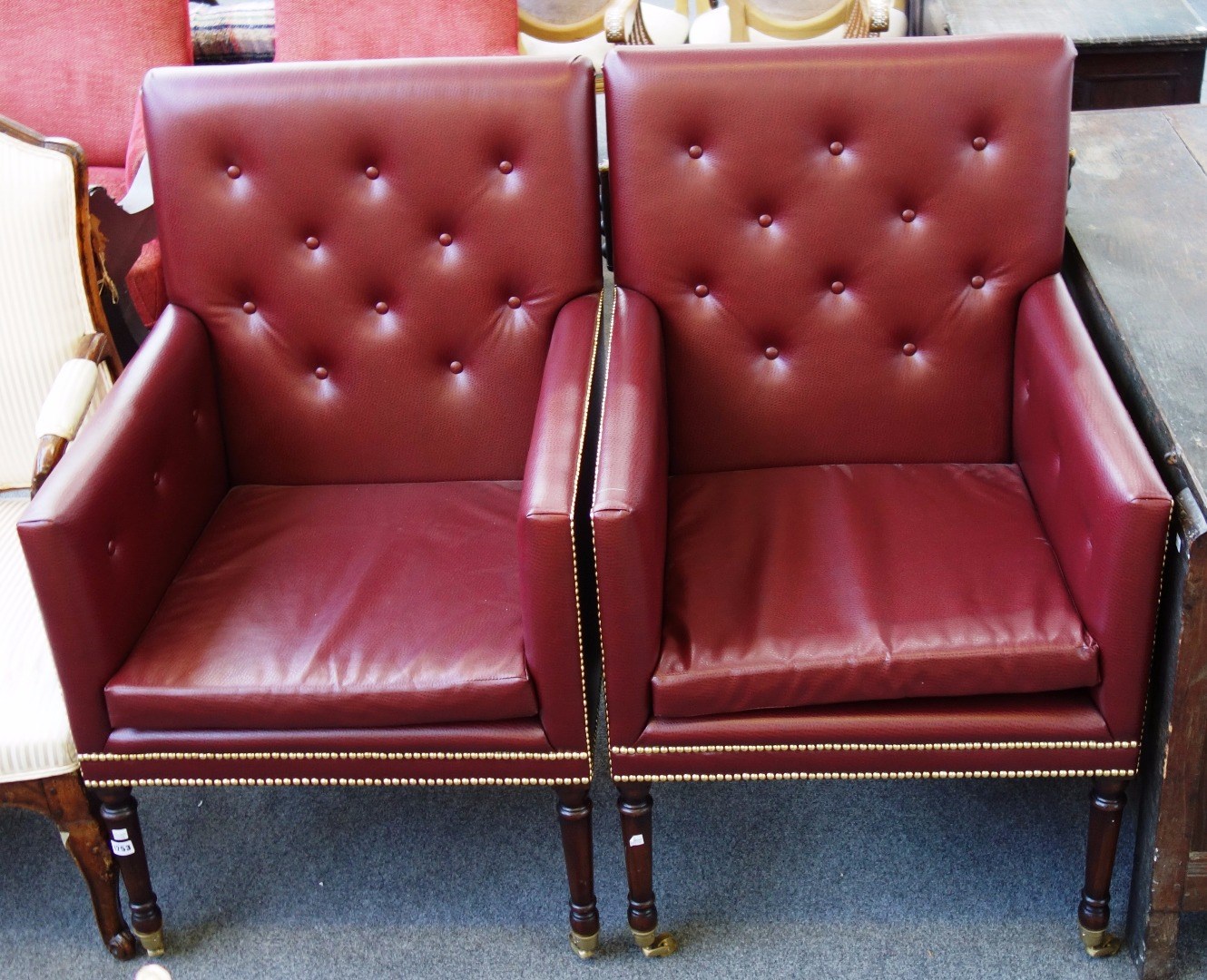 Appraisal: A pair of George III style square back armchairs with