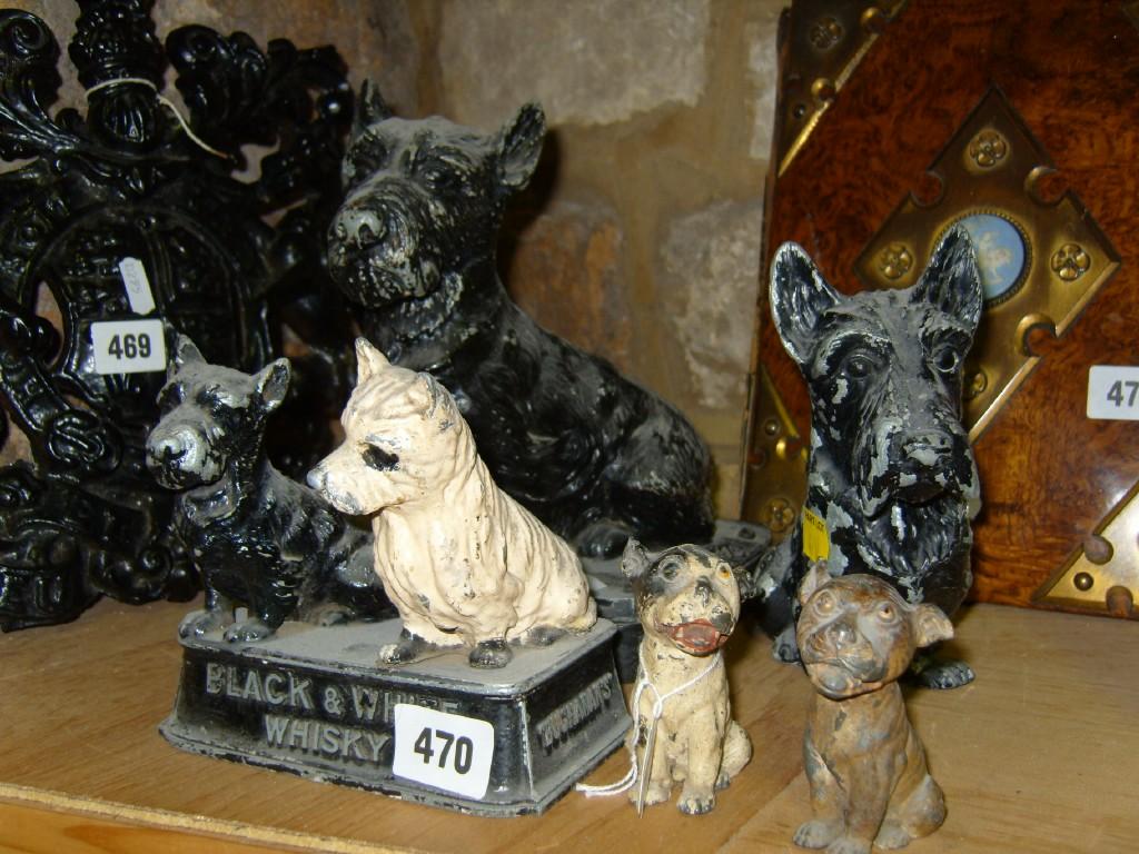 Appraisal: A cast metal advertising group of Scottie dog and Highland