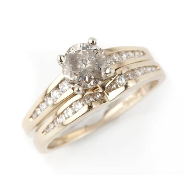 Appraisal: A diamond and k gold solitaire with a diamond and