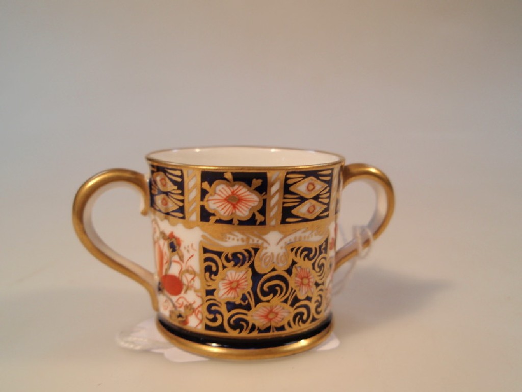 Appraisal: A Royal Crown Derby miniature loving cup decorated with Old