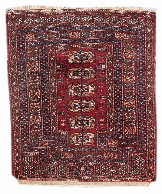 Appraisal: A PERSIAN YOMUT WINE GROUND SMALL RUG with multiple border