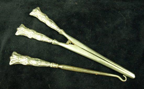 Appraisal: A pair of glove stretchers with embossed silver handles and