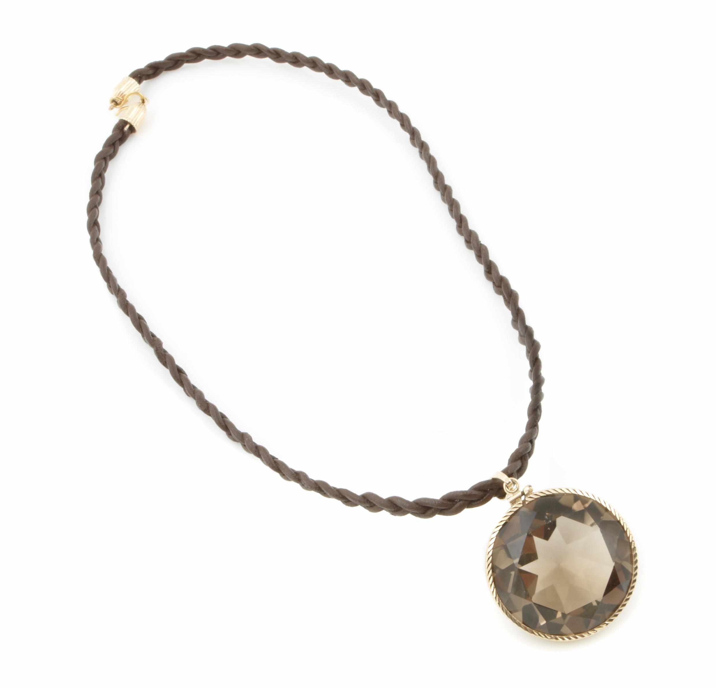 Appraisal: A smokey quartz and k gold pendant with a brown