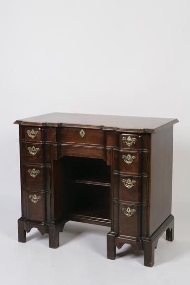 Appraisal: AN AMERICAN STYLE KNEEHOLE WRITING DESK the shaped rectangular top