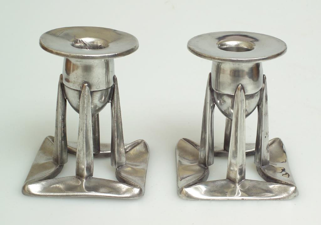 Appraisal: PAIR OF LIBERTY CO ENGLISH PEWTER CANDLESTICKS DESIGNED BY ARCHIBALD