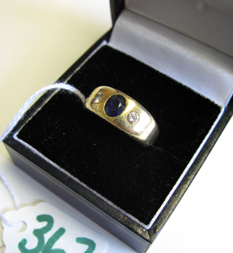 Appraisal: SAPPHIRE DIAMOND AND EIGHTEEN KARAT GOLD RING centering an oval-cut