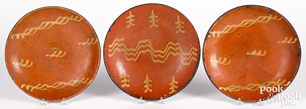 Appraisal: Three Pennsylvania redware plates th c Three Pennsylvania redware plates