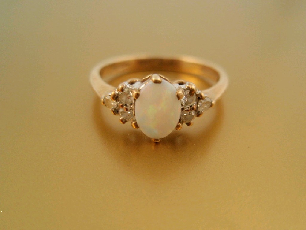 Appraisal: A ladies opal and diamond dress ring a central opal