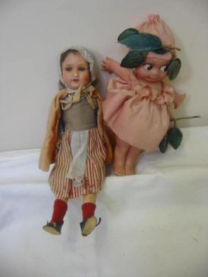 Appraisal: A celluloid Kewpie doll with painted face swivel arms and