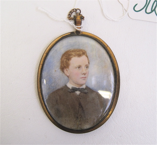 Appraisal: GILT METAL OVAL PORTRAIT PENDANT color drawing of a young