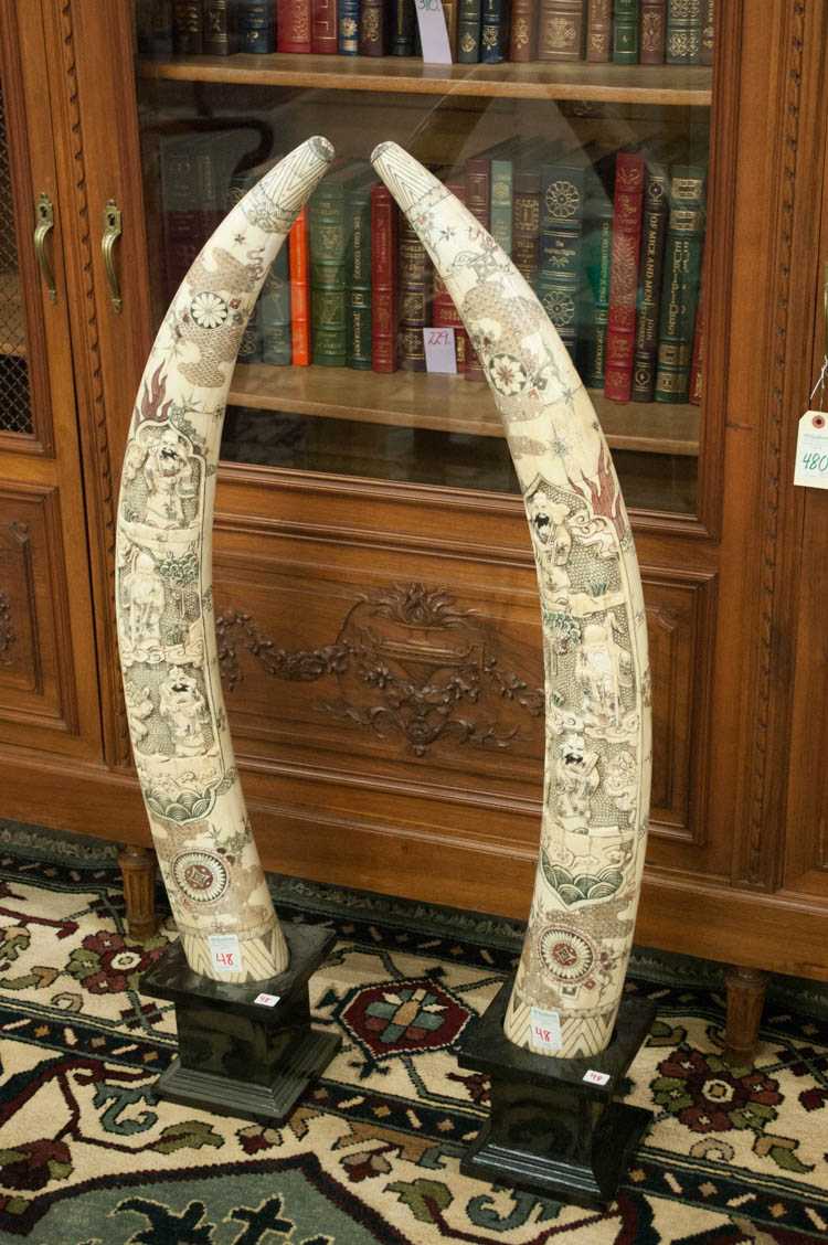 Appraisal: PAIR OF CHINESE CARVED BONE TUSKS scrimshawed and with figural