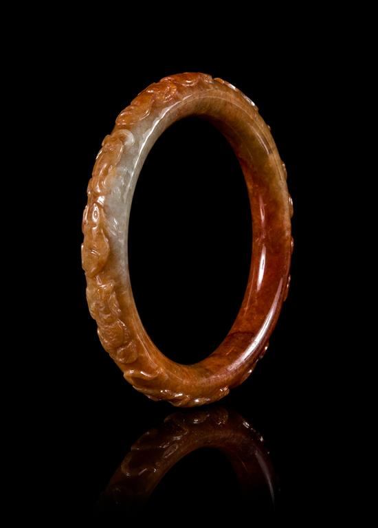 Appraisal: Sale Lot A Russet Jadeite Bangle carved in relief to